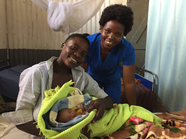 Judith Neilson Foundation - We Care Solar. uganda-midwife-mother-and-baby-scaled-1